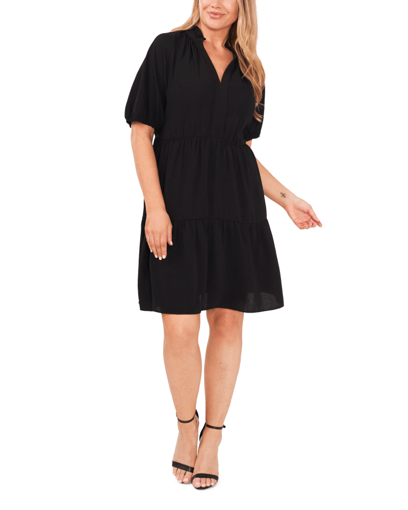 Front of a model wearing a size 1X Odette Tiered Dress in RICH BLACK by CeCe. | dia_product_style_image_id:263794
